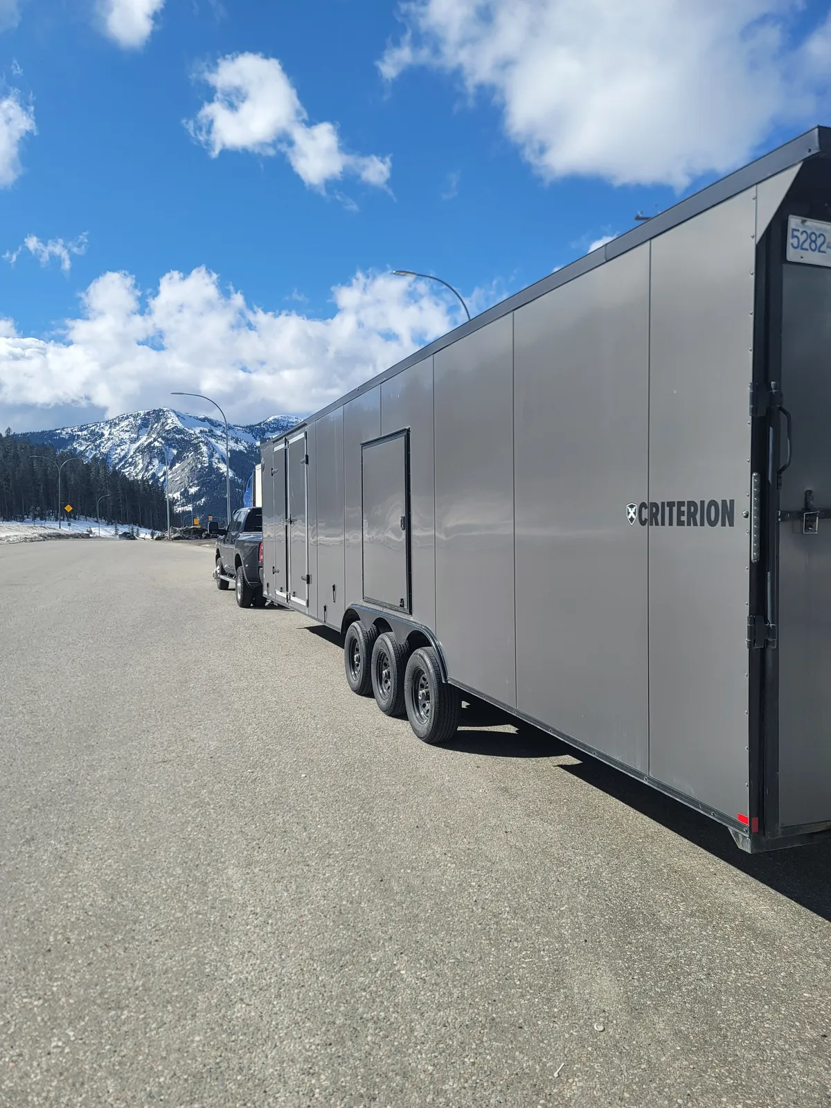 Coast2Coast enclosed gooseneck trailer and truck on a mountain route.